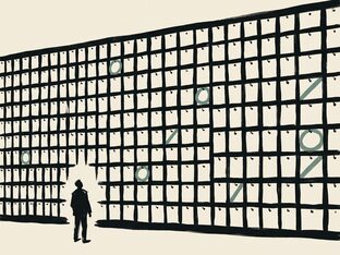 A person standing small before a wall of hundreds of pinned index cards